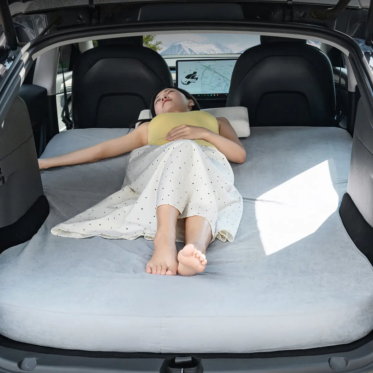 Havnby Perfect Fit Bed Sheet covering a mattress in a Tesla cargo area, with a person lying on the surface
