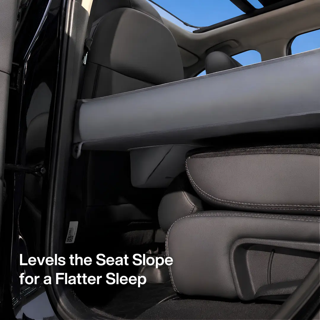 Havnby product photograph of a padded edge section positioned across the tops of a vehicle folded rear seatbacks