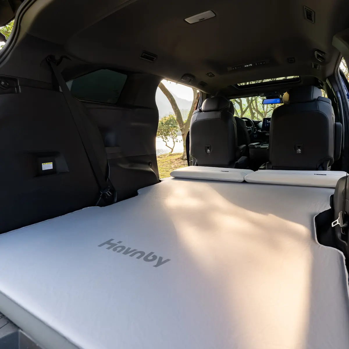 Havnby FlatCore mattress placed inside a Toyota Sienna cargo area with the embossed Havnby wordmark visible