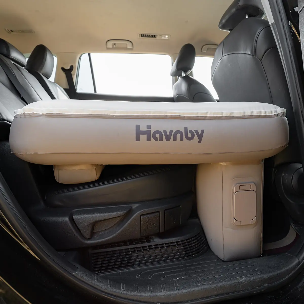 Havnby SnugNest pad installed behind the second-row seats of a Toyota Highlander, viewed through the open rear liftgate