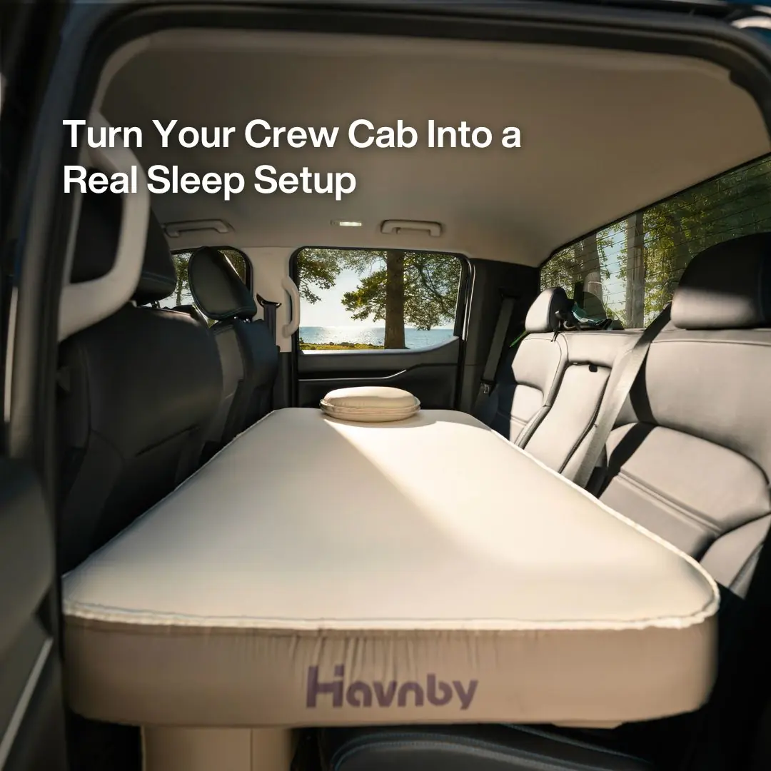 Havnby SnugNest pad viewed from inside a truck cab, with on-image text reading Turn Your Crew Cab Into a Real Sleep Setup