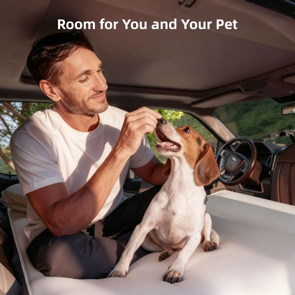 Man and dog on the installed Havnby SnugNest Truck Sleep System pad