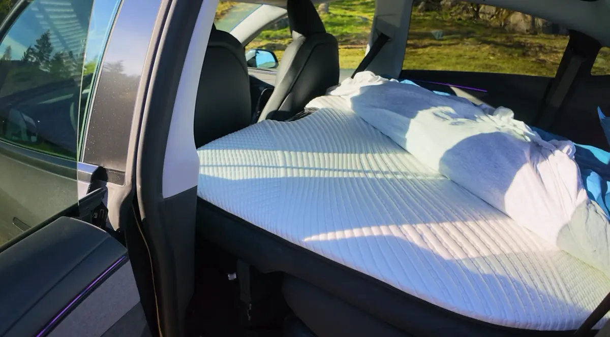 The operator’s own Snuuzu Model Y inflated in a Tesla Model Y, seen through the rear door